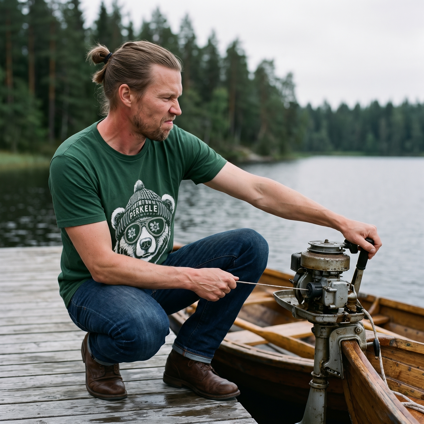 Perkele Bear t-shirt in forest green, worn by a man starting an outboard motor on a Finnish lake jetty, Very Finnish Problems