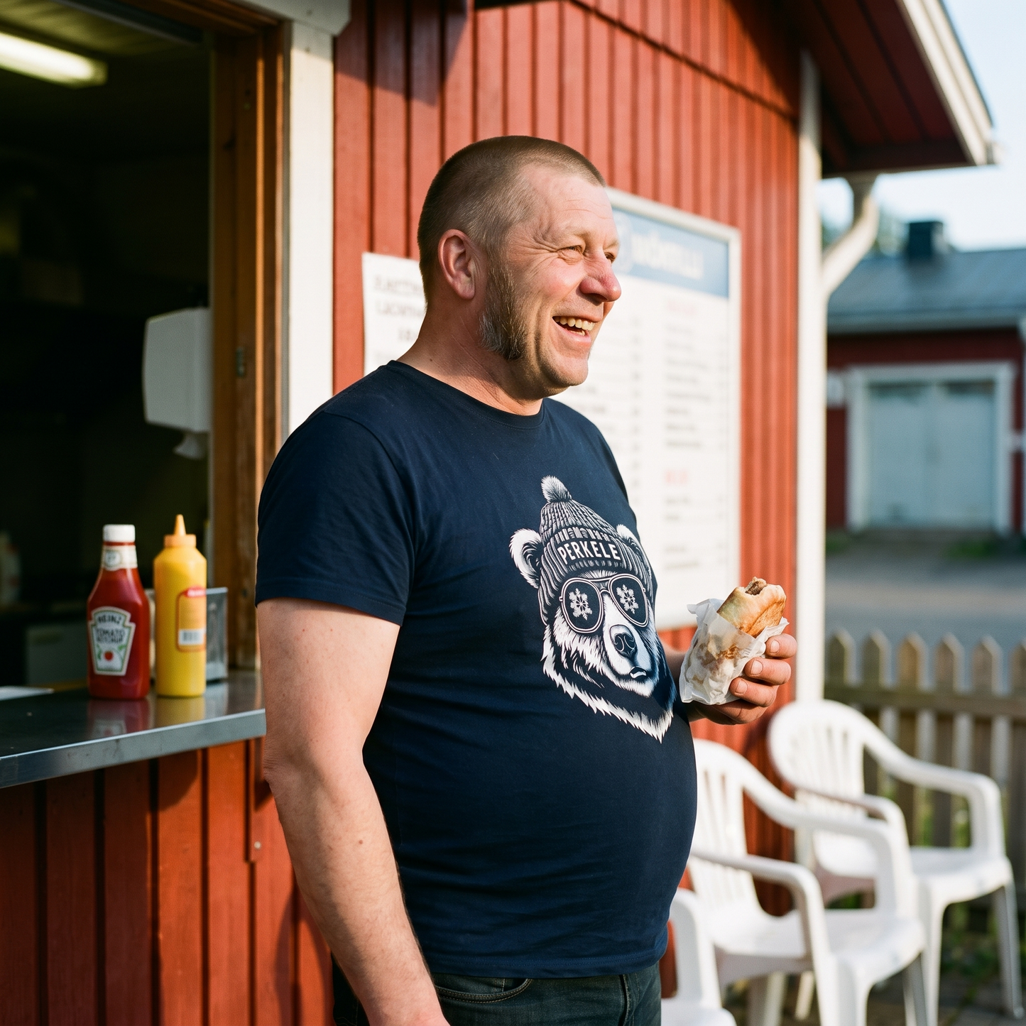 Perkele Bear t-shirt in navy, worn by a man laughing outside a Finnish grilli kiosk, Very Finnish Problems