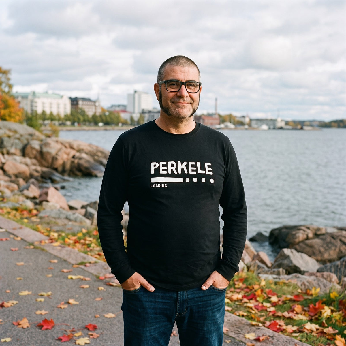 Perkele loading long sleeve tee in black, worn by Jaska on a Helsinki seaside path, Very Finnish Problems
