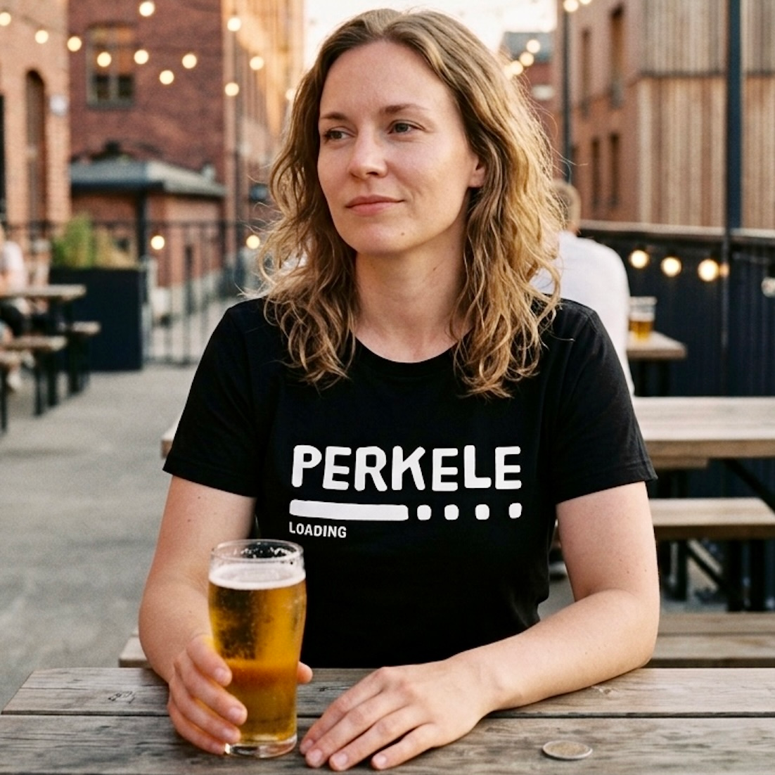 Perkele loading Finnish language t-shirt in black, worn at an outdoor bar terrace, Very Finnish Problems