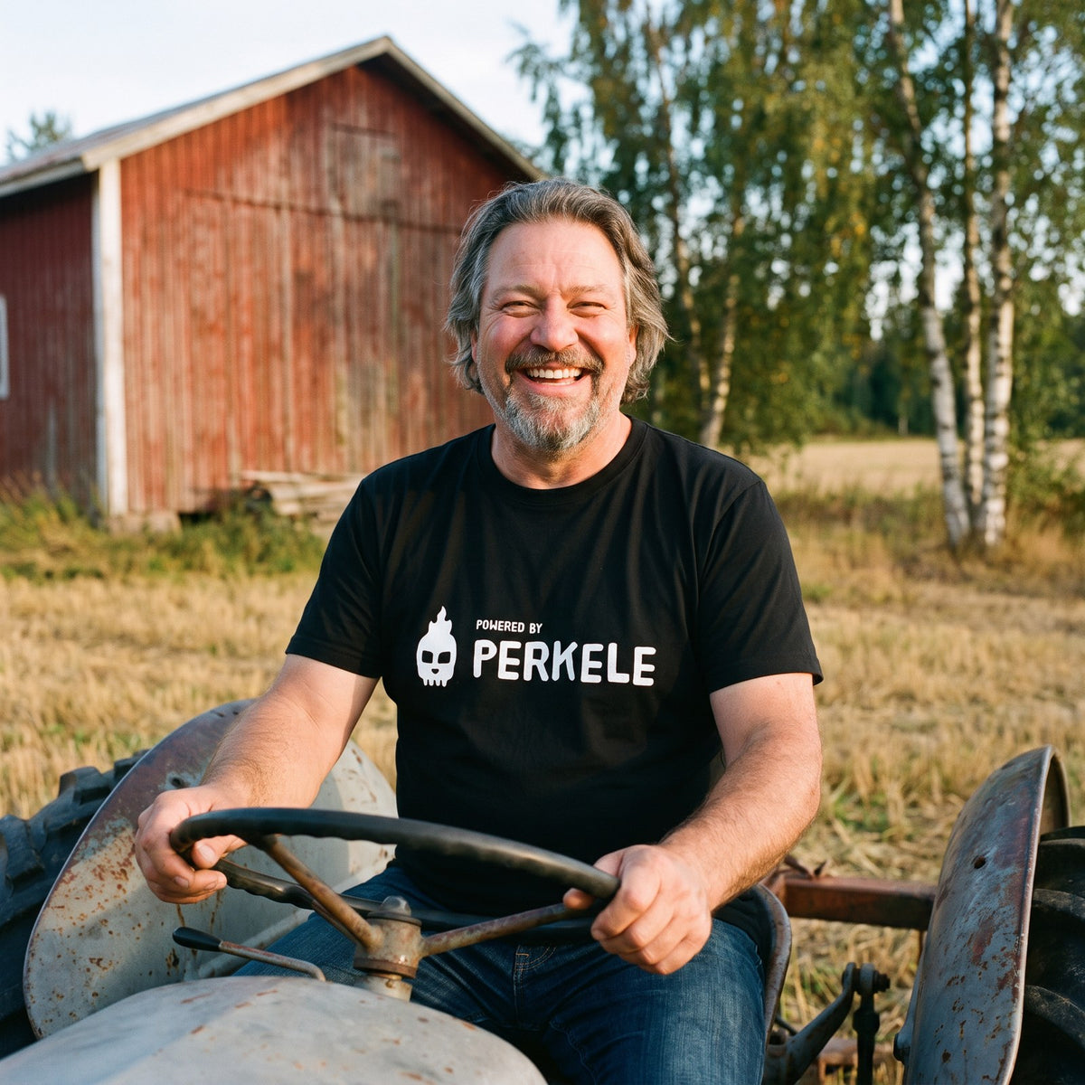 Powered by Perkele organic t-shirt in black, worn by Jojelli on an old tractor, Very Finnish Problems
