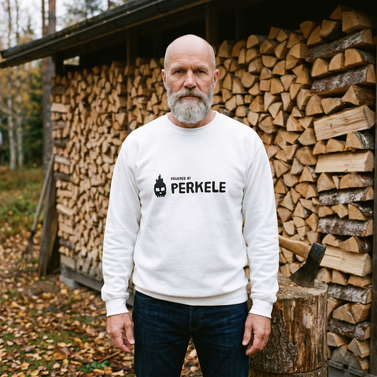 Powered by Perkele sweatshirt in white, worn by Mikko beside a cottage woodpile, Very Finnish Problems