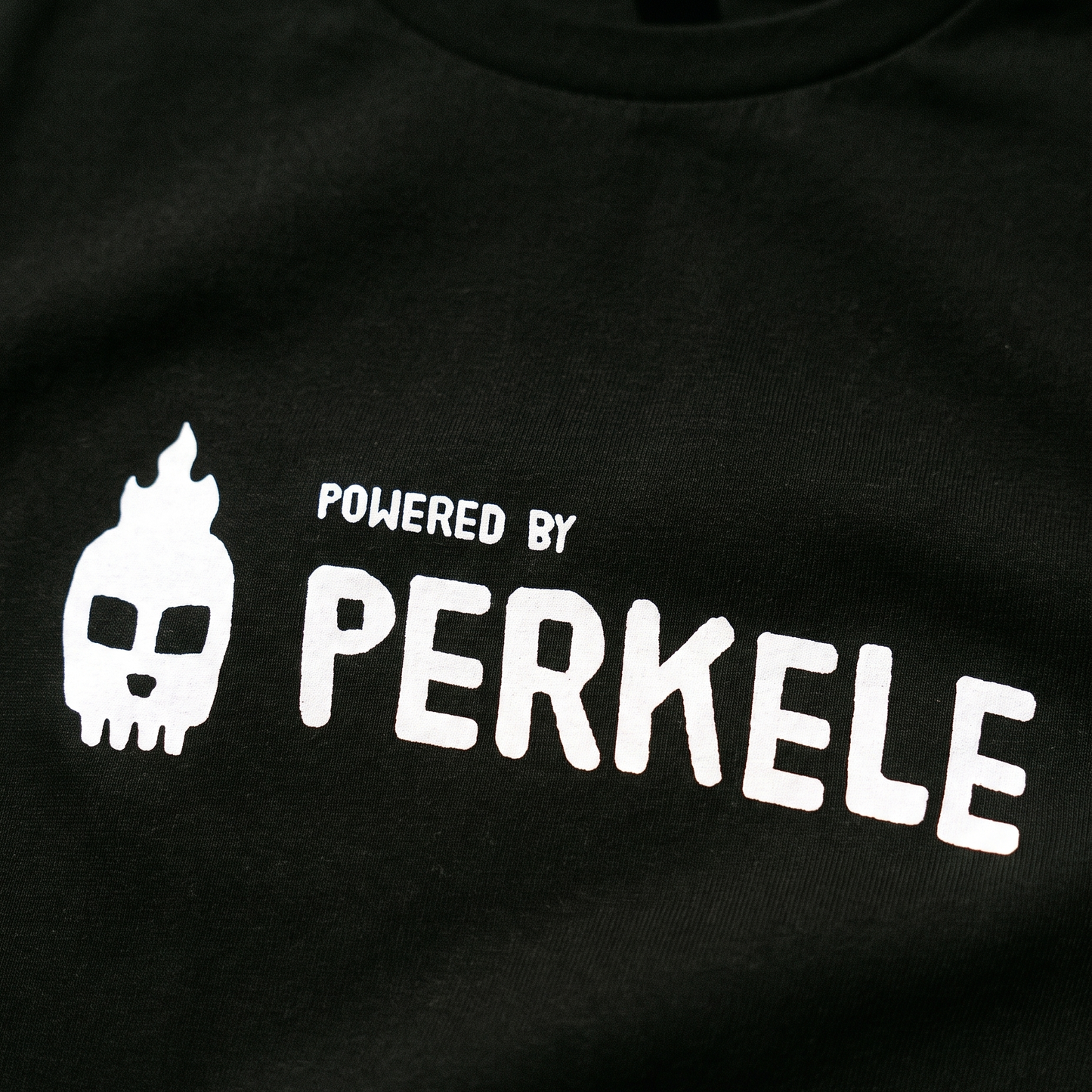 Powered by perkele print close up on black cotton, Very Finnish Problems