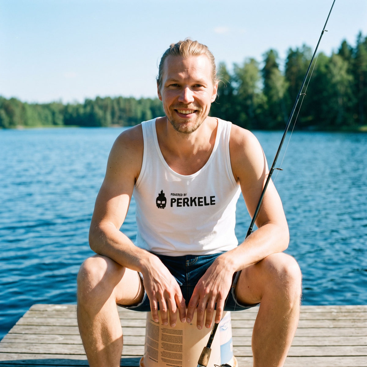 Powered by Perkele tank top in white, worn by Joonas fishing from a lake jetty, Very Finnish Problems