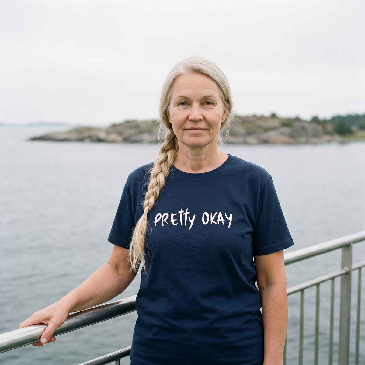 Pretty okay Finnish humour organic cotton t-shirt in French navy, worn by Anneli on an archipelago ferry deck, Very Finnish Problems