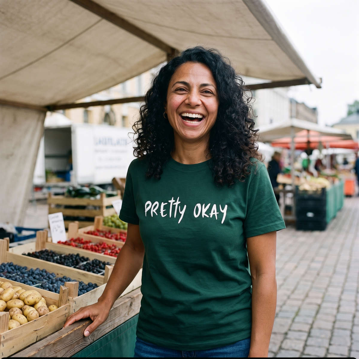 Pretty Okay t-shirt in forest, worn by a woman at an outdoor market stall, Very Finnish Problems