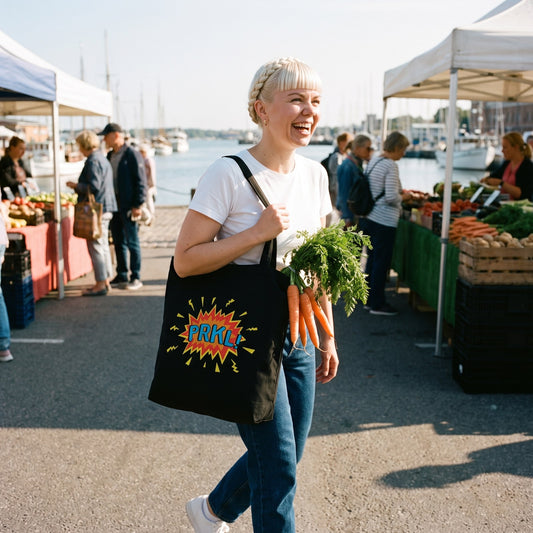 PRKL Bang eco tote bag in black, carried by Venla at the Helsinki harbour market, Very Finnish Problems