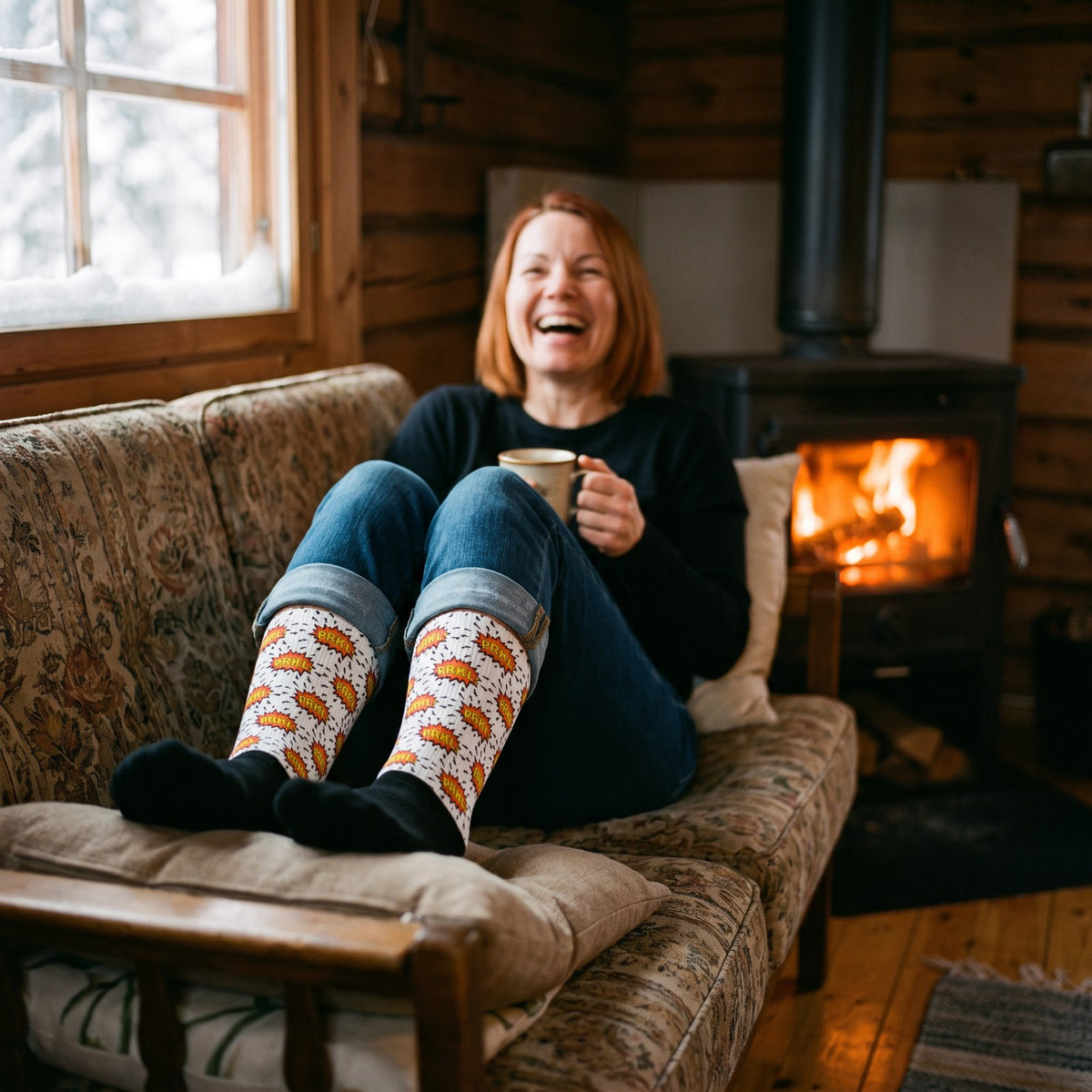 PRKL Bang socks, worn by Sanna on a log cabin sofa by the stove, Very Finnish Problems