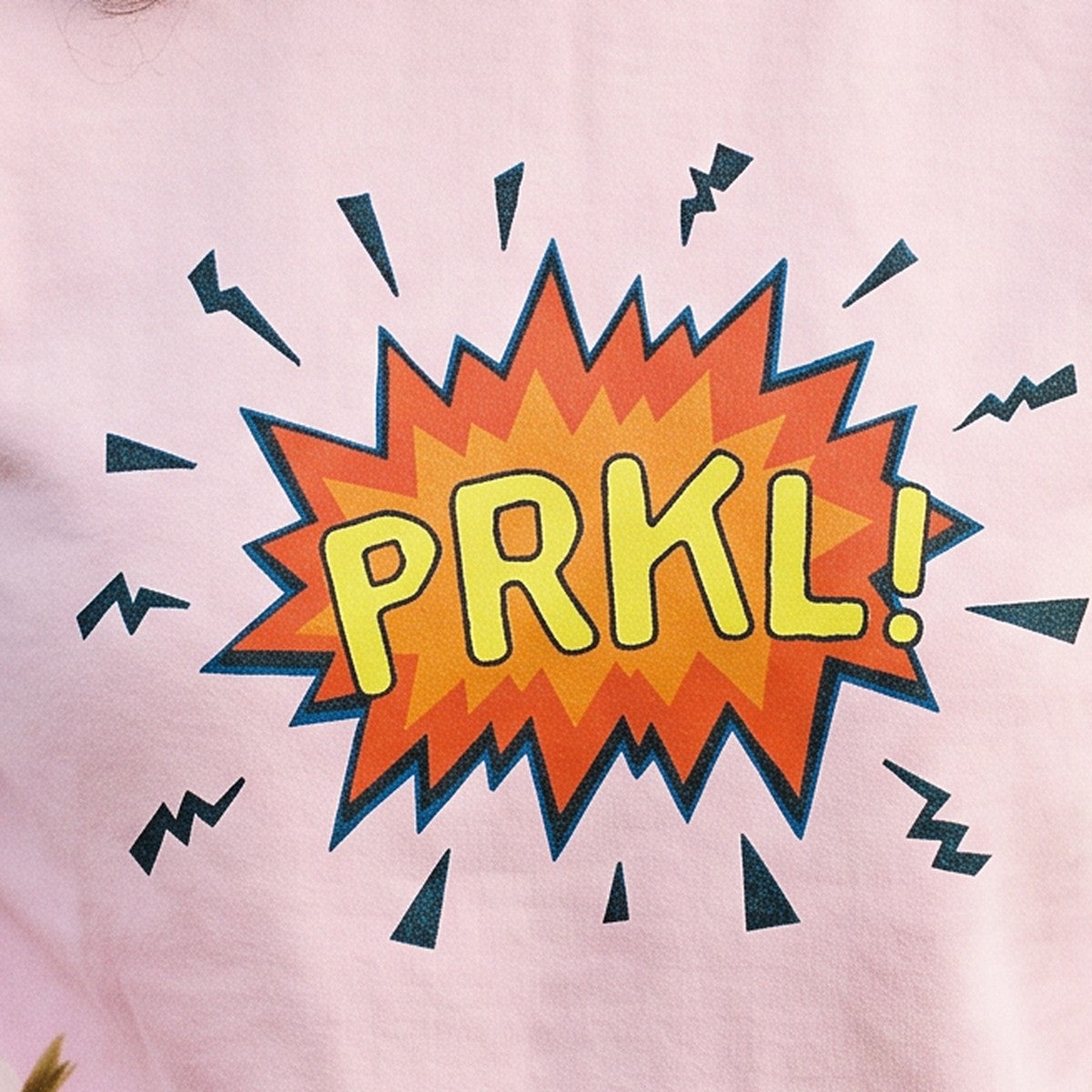 Close-up of the PRKL Bang print on light pink sweatshirt fabric, Very Finnish Problems
