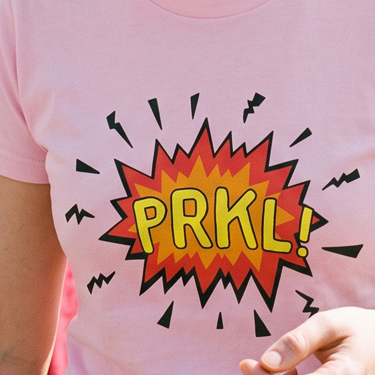 Close-up of the print on the pink PRKL Bang t-shirt, Very Finnish Problems