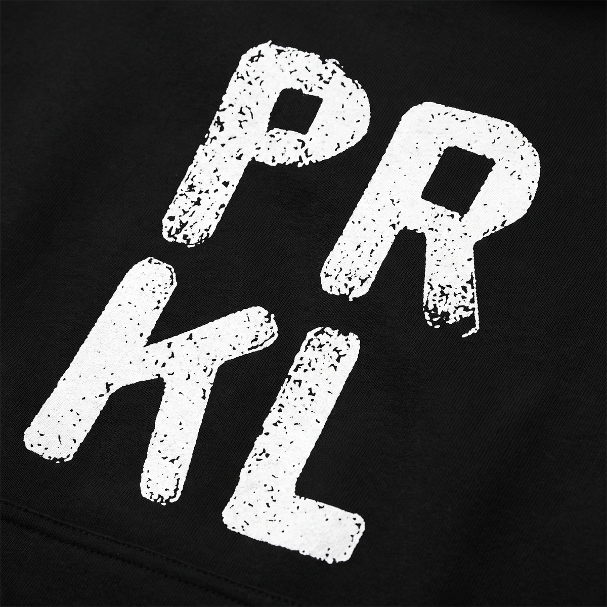 Close-up of the PRKL print on black hoodie fabric, Very Finnish Problems