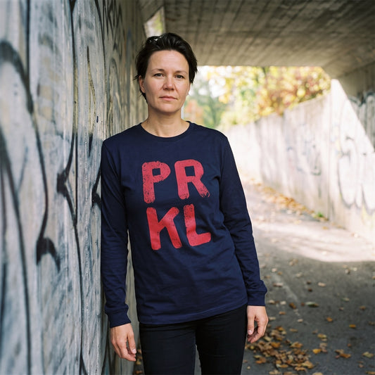 PRKL long sleeve tee in navy, worn by Katja in a painted underpass, Very Finnish Problems
