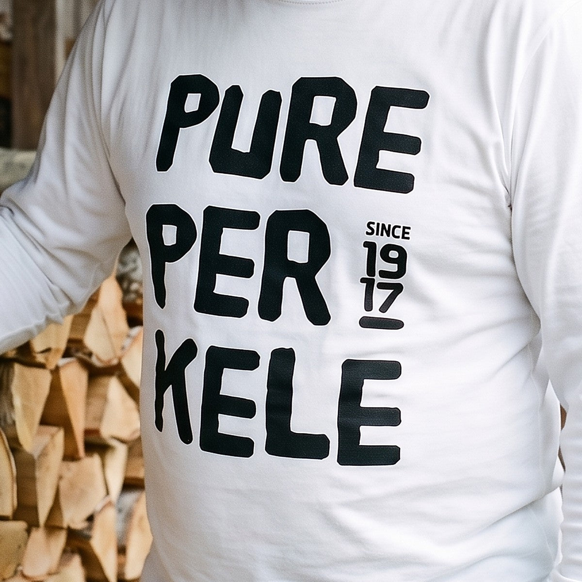 Close-up of the Pure Perkele since 1917 print on white long sleeve tee fabric, Very Finnish Problems