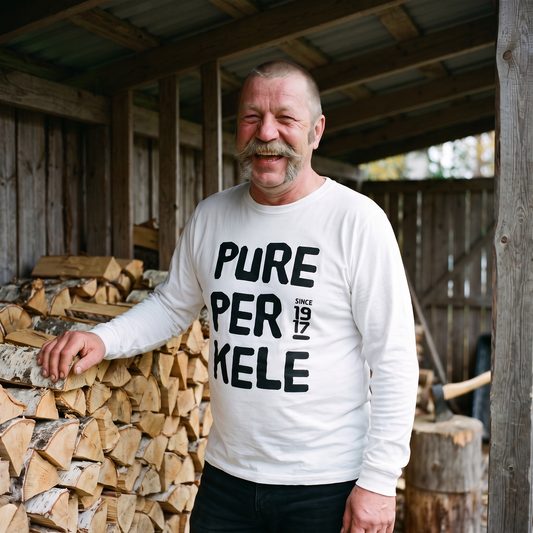 Pure Perkele Since 1917 long sleeve tee in white, worn by a man laughing at a cottage woodpile, Very Finnish Problems