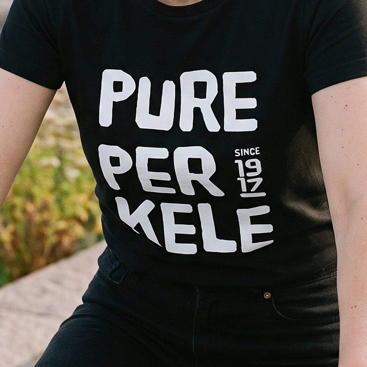 Close-up of the print on the black Pure Perkele since 1917 organic t-shirt, Very Finnish Problems