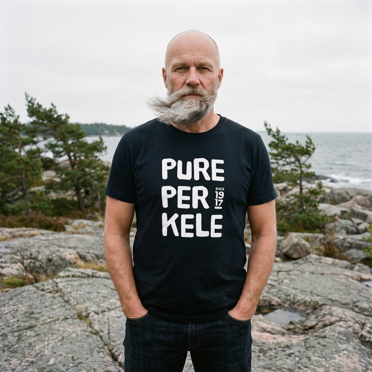 Pure Perkele since 1917 t-shirt in black, worn by Mikko on coastal rocks, Very Finnish Problems