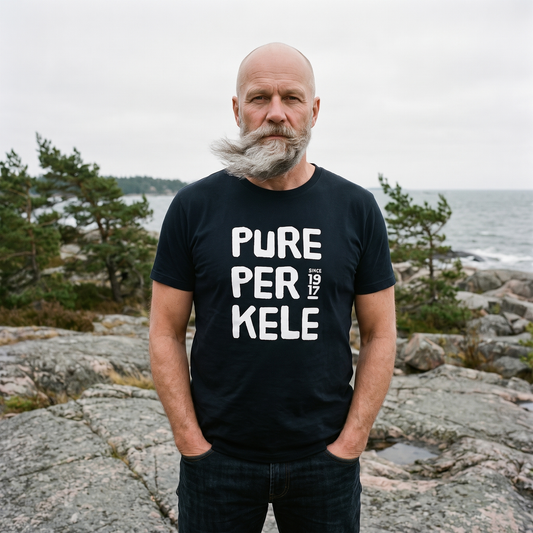 Pure Perkele since 1917 t-shirt in black, worn by Mikko on coastal rocks, Very Finnish Problems