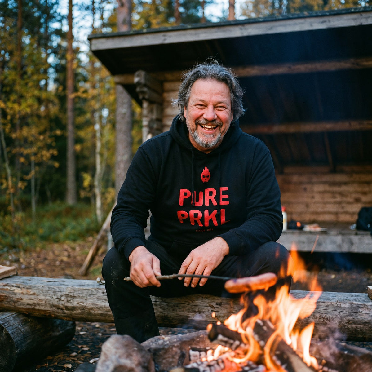 Pure PRKL hoodie in black, worn by Jojelli at a campfire, Very Finnish Problems