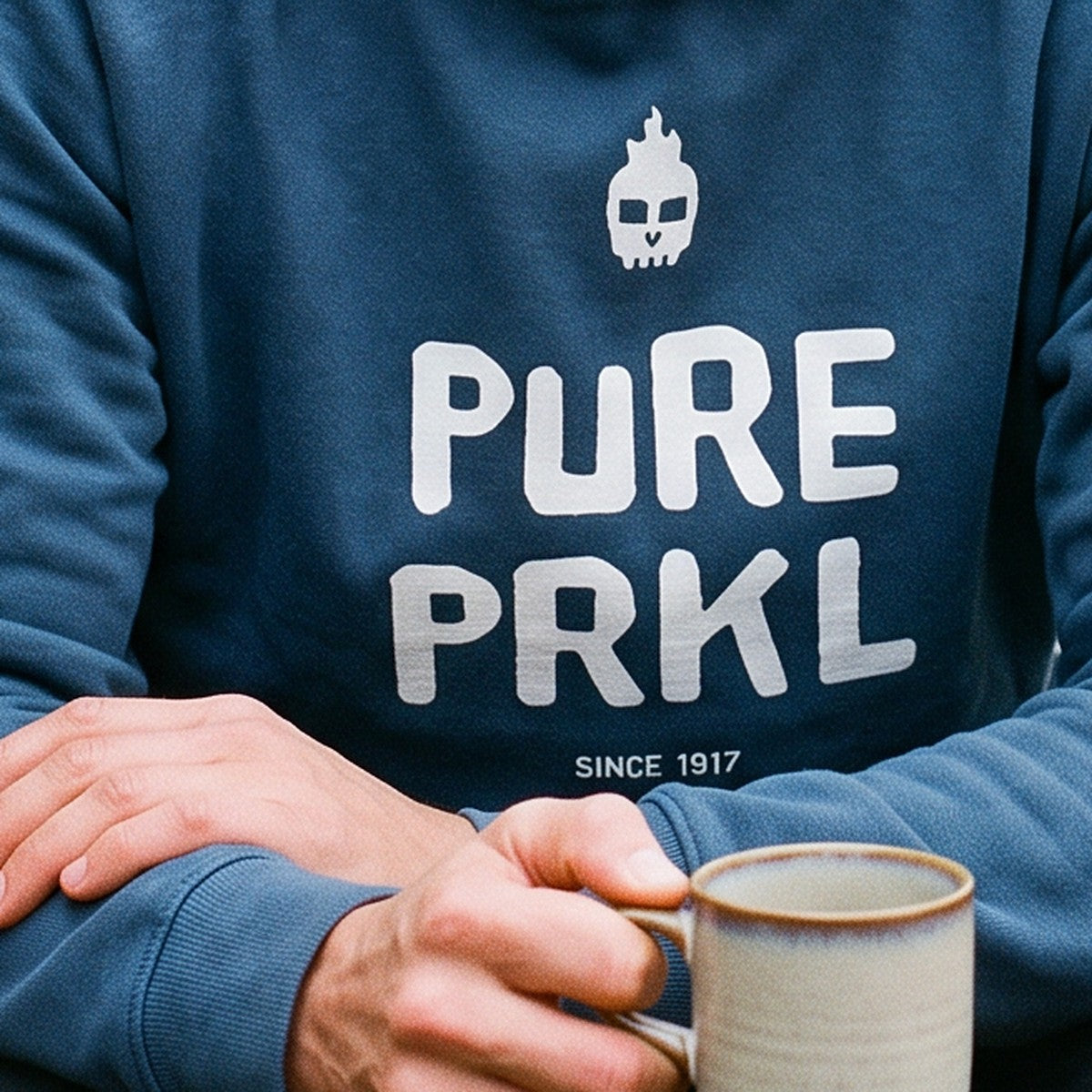Close-up of the print on the indigo blue Pure PRKL hoodie, Very Finnish Problems