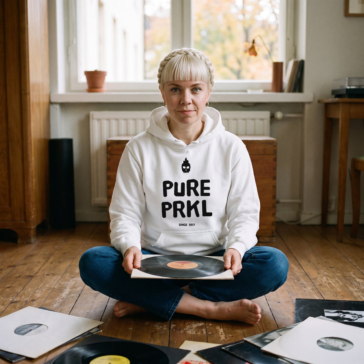 Pure PRKL hoodie in white, worn by Venla sorting records at home, Very Finnish Problems