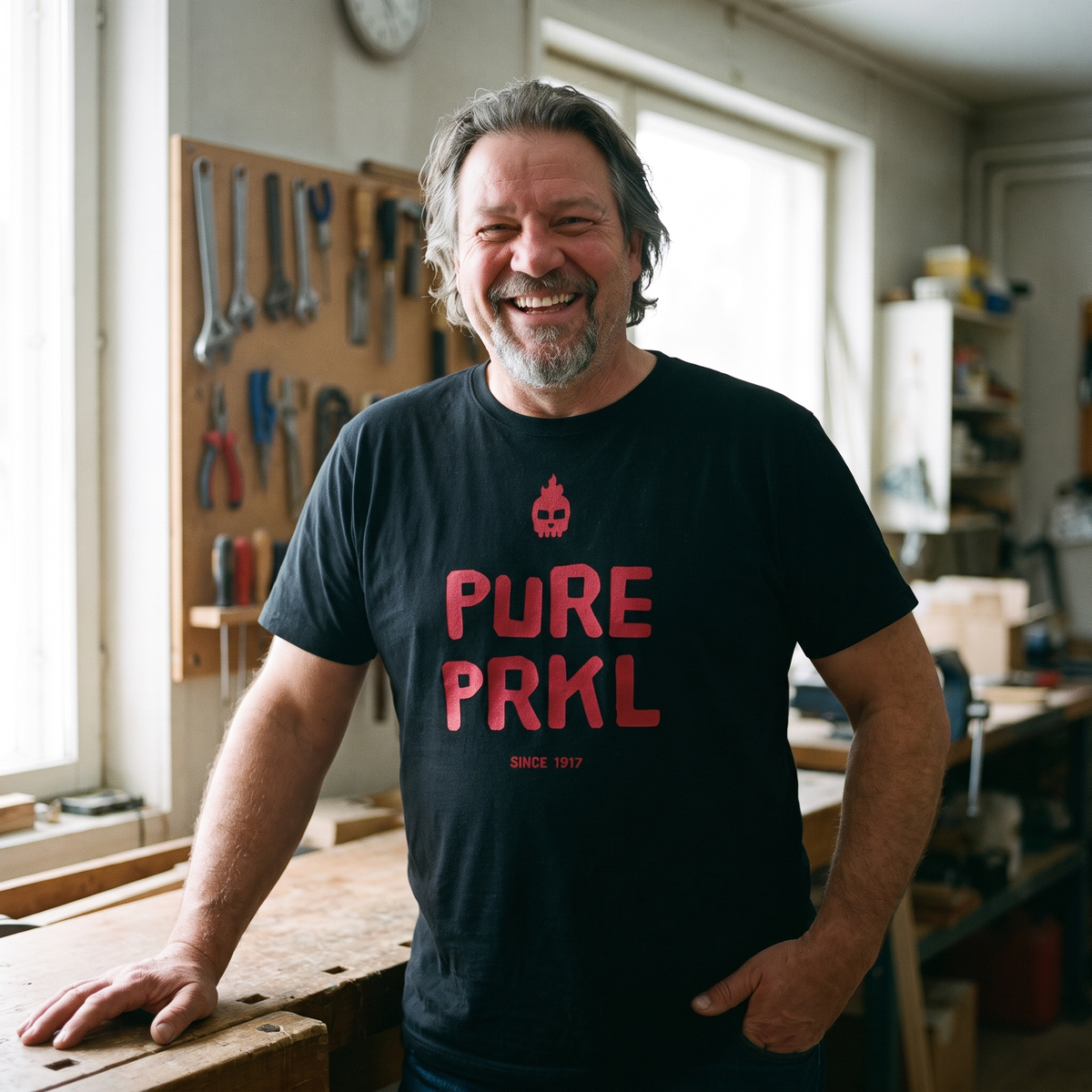 Pure PRKL Finnish language t-shirt in black, worn by Jojelli in his workshop, Very Finnish Problems