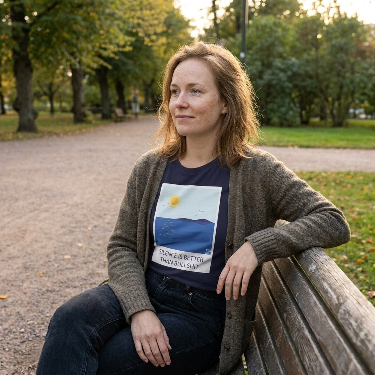 Finnish woman on a park bench wearing the navy Silence Is Better Than Bullshit t-shirt, Very Finnish Problems