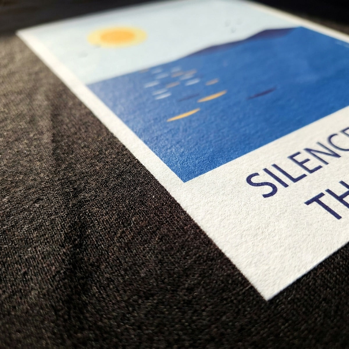 Close-up of the Silence Is Better Than Bullshit print on black cotton fabric, Very Finnish Problems