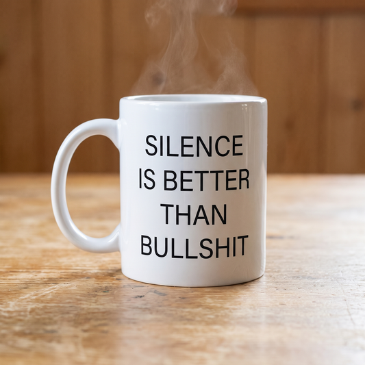 Silence Beats Bullshit mug in white, steaming on a pine kitchen table, Very Finnish Problems