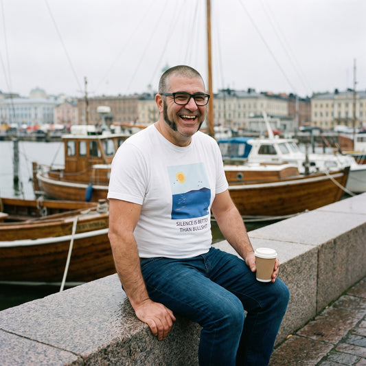 Silence Beats Bullshit t-shirt in white, worn by Jaska on a Helsinki harbour quay, Very Finnish Problems