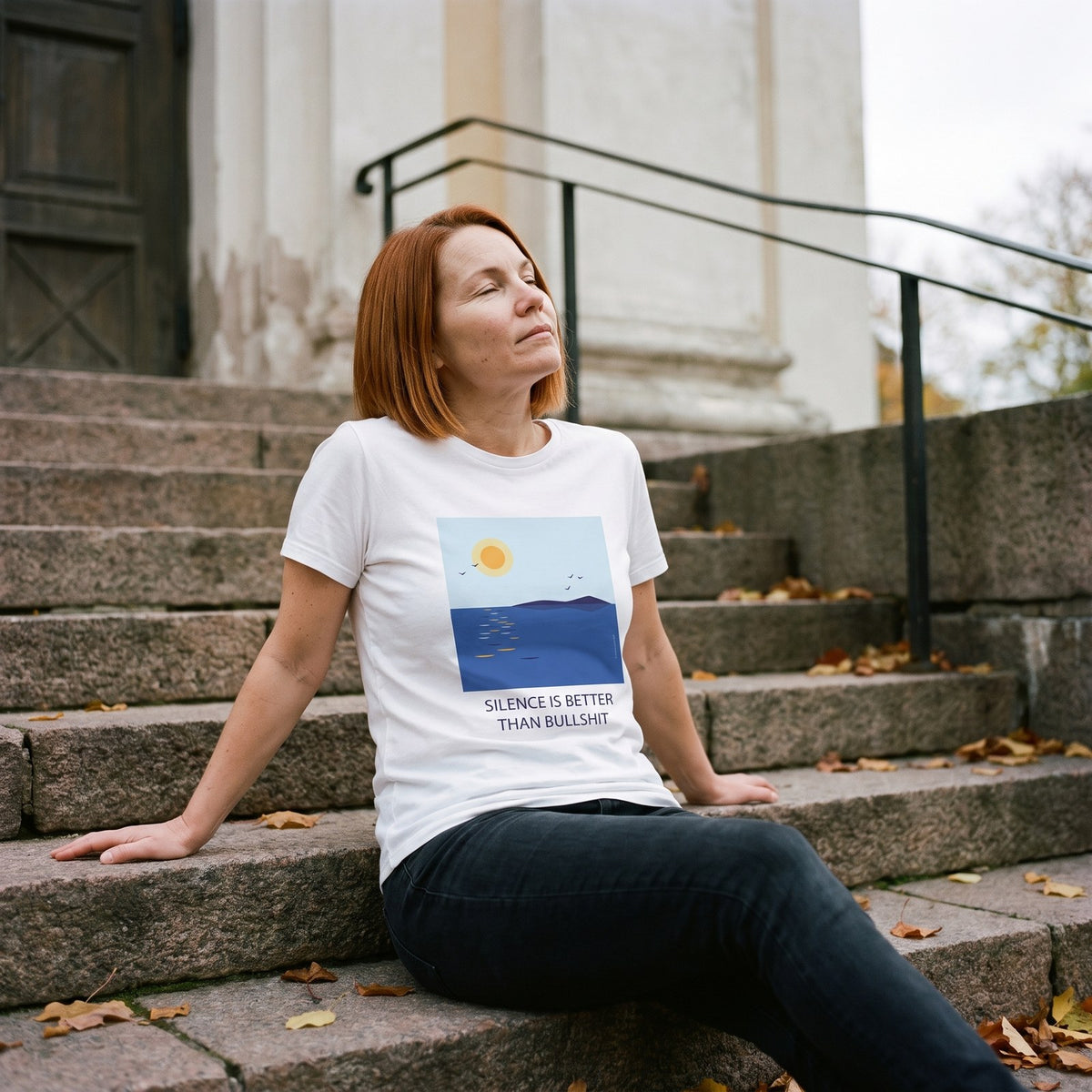Silence Is Better Than Bullshit organic t-shirt in white, worn by Sanna on old Helsinki church steps, Very Finnish Problems