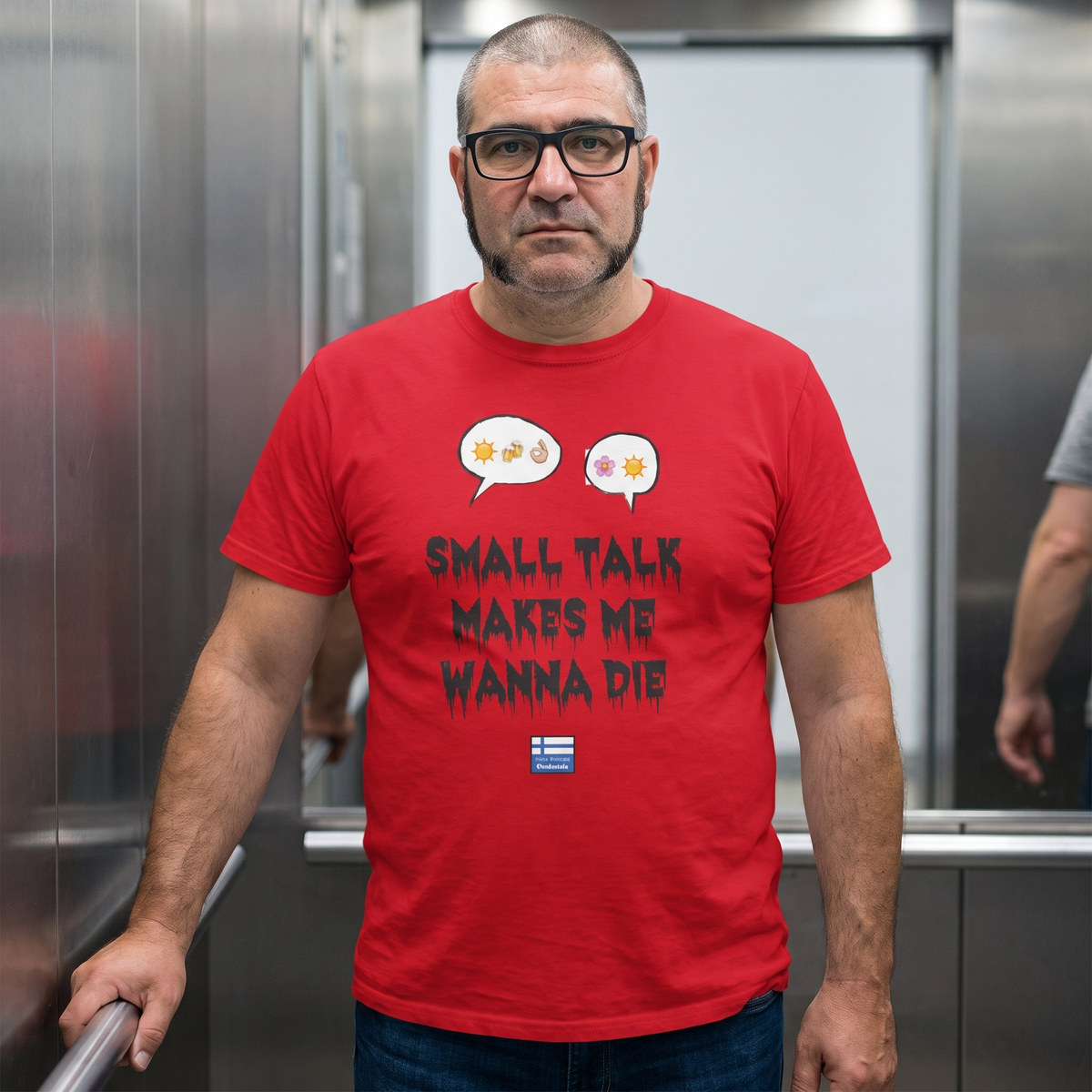 Small Talk Makes Me Wanna Die t-shirt in red, worn by Jaska in a lift dreading the weather chat, Very Finnish Problems