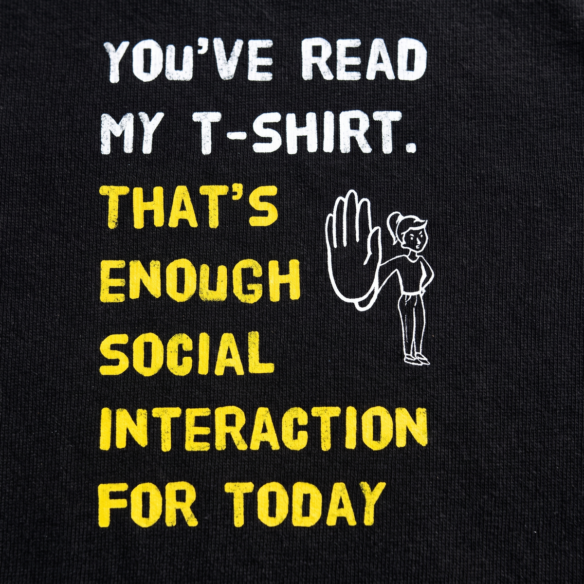 Close-up of the Social Interaction girl print on black t-shirt fabric, Very Finnish Problems