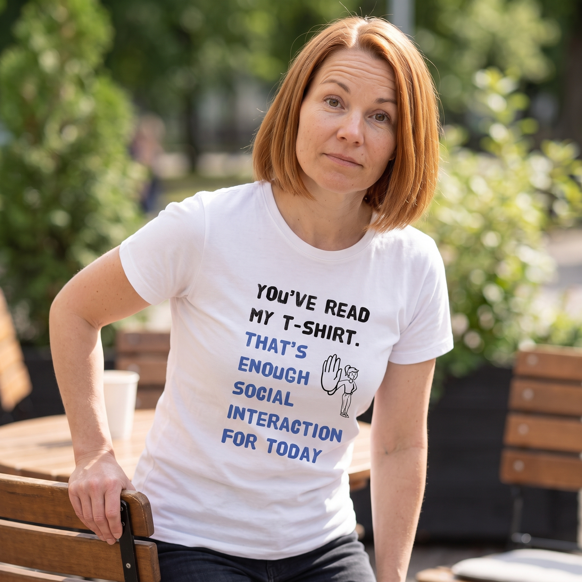 Social Interaction girl Finnish introvert t-shirt in white, worn by Sanna leaving a cafe terrace, Very Finnish Problems