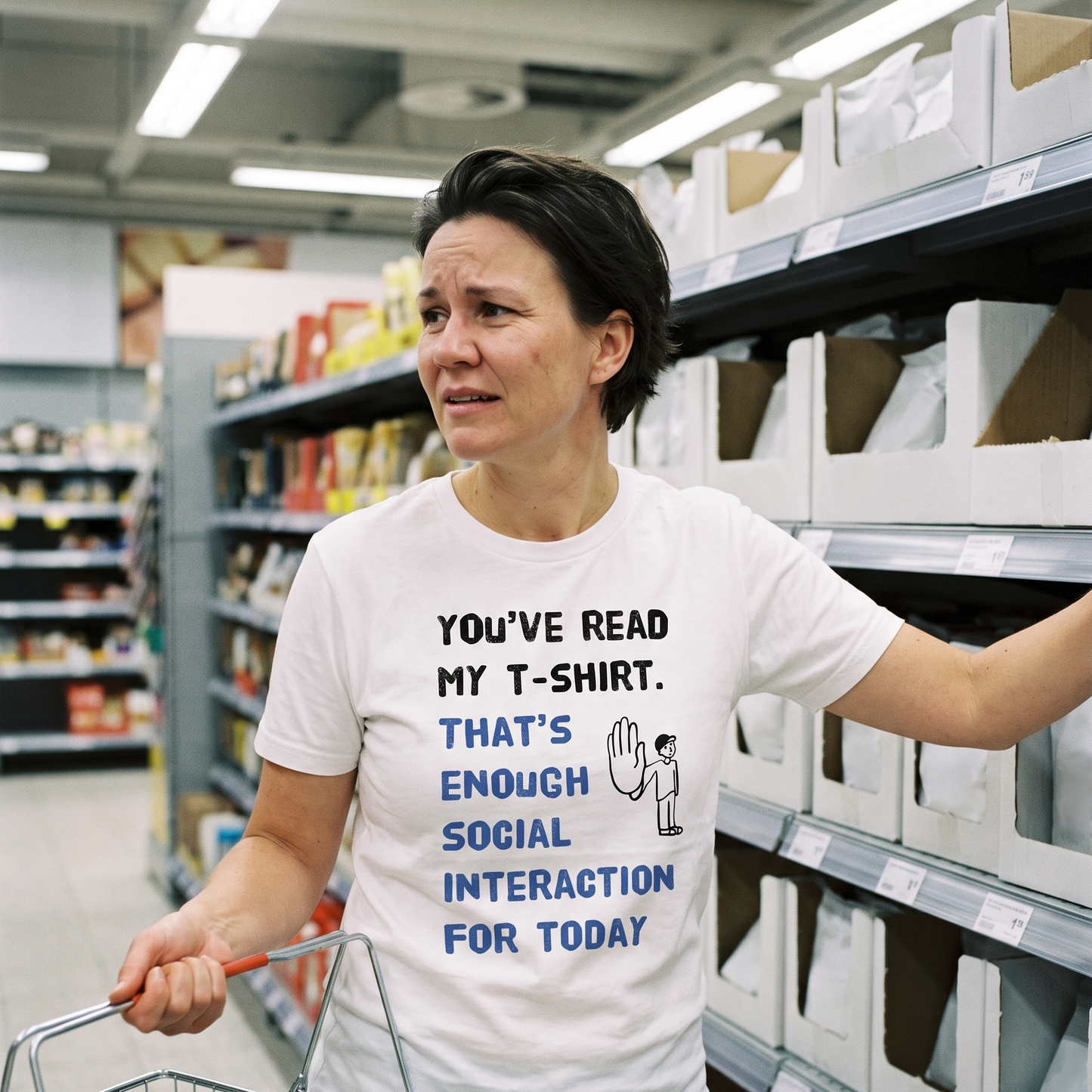 Social Interaction t-shirt in white, worn by Katja avoiding eye contact in a supermarket aisle, Very Finnish Problems