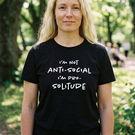 Woman in a Helsinki park wearing the black Solitude Finnish t-shirt by Very Finnish Problems