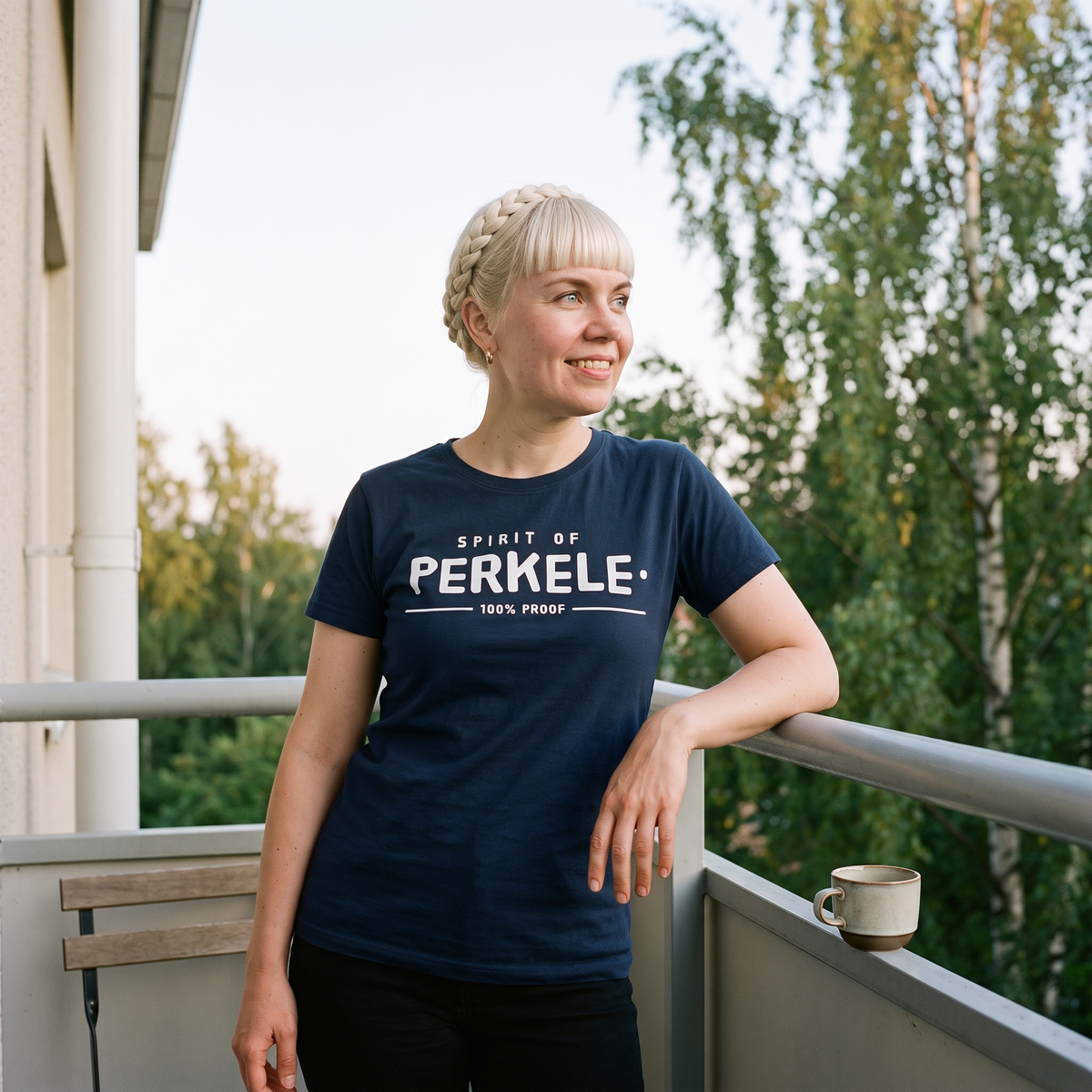 Spirit of Perkele t-shirt in navy, worn by a woman on an apartment balcony, Very Finnish Problems