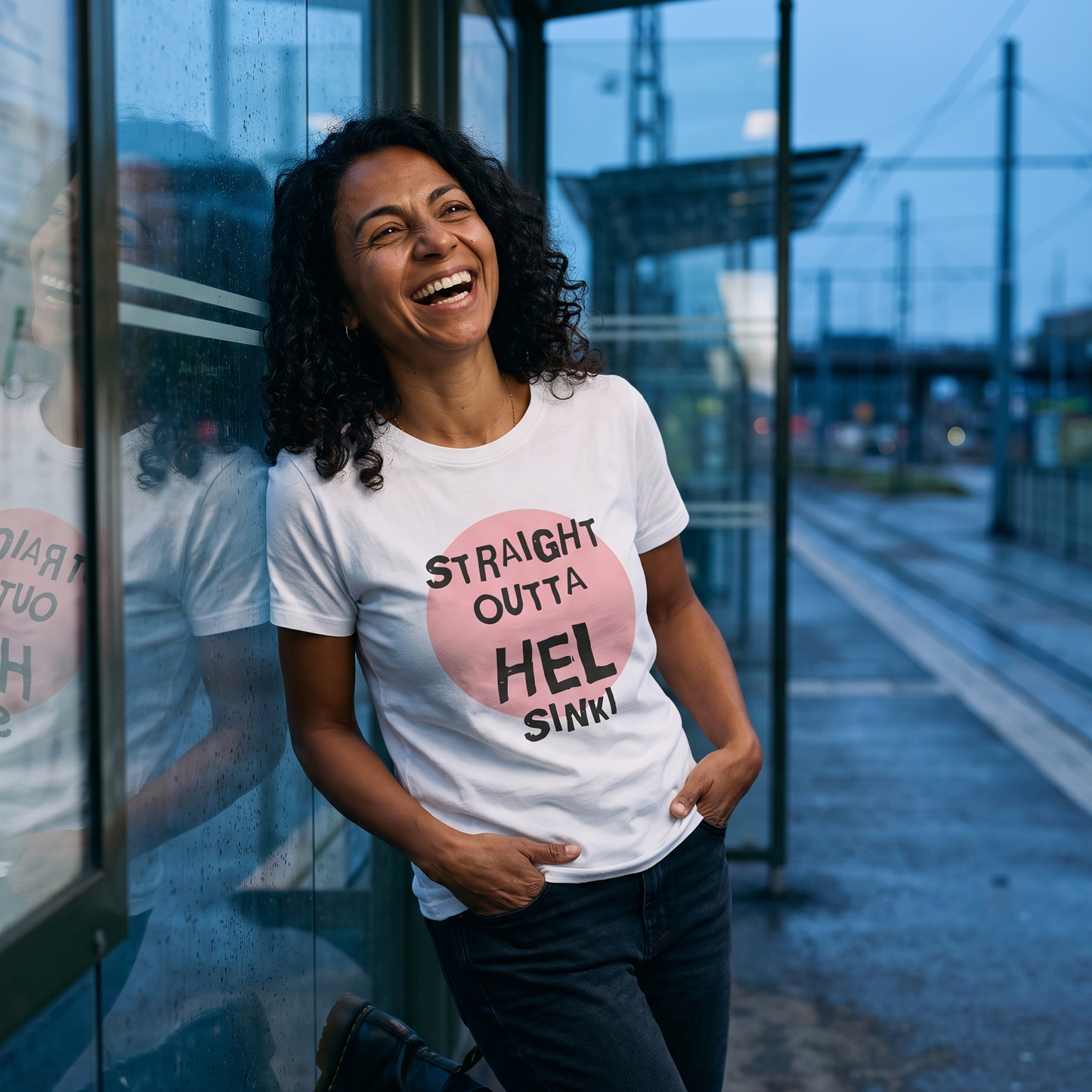 Straight Outta Hel t-shirt in white, worn by Nea at a Finnish tram stop at dusk, Very Finnish Problems