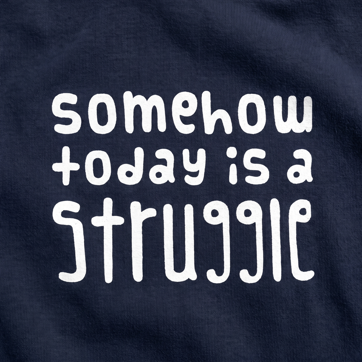 Close-up of the Somehow today is a struggle print on fabric, Very Finnish Problems