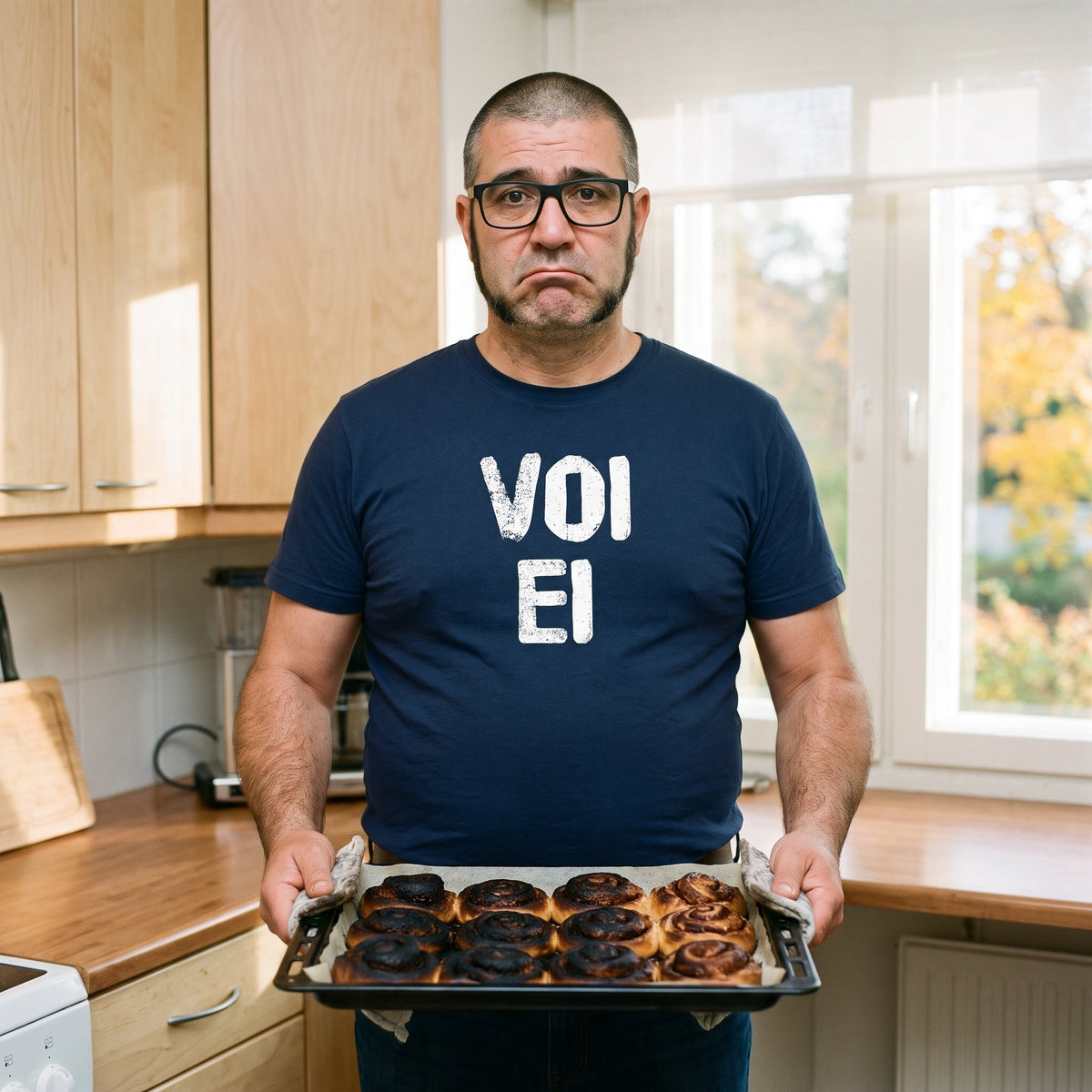 Voi ei Finnish language t-shirt in navy, worn by Jaska holding a tray of burnt cinnamon buns, Very Finnish Problems