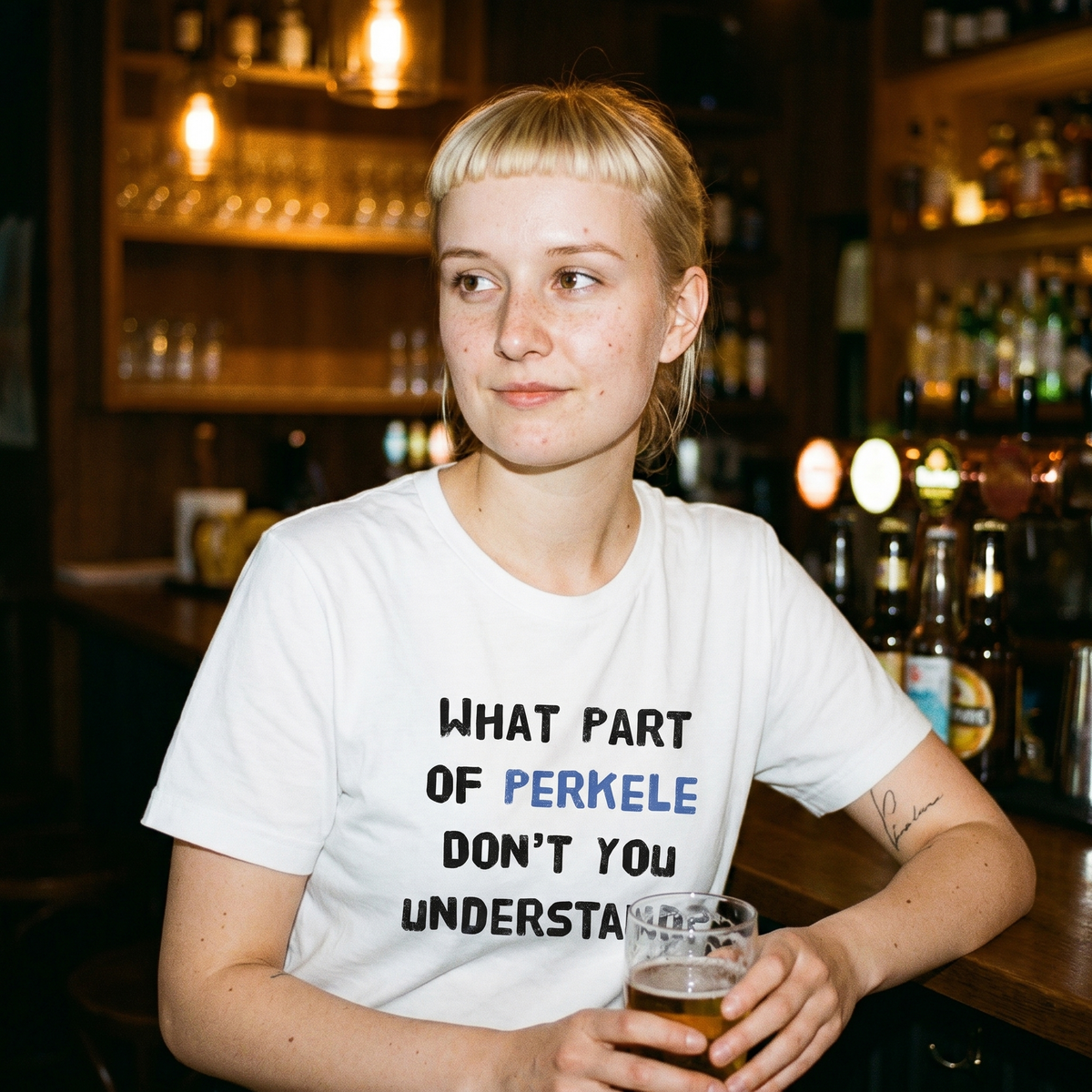 What part of perkele don't you understand t-shirt in white, worn by a woman in a Helsinki bar, Very Finnish Problems