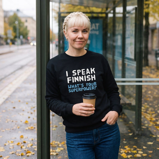 What's Your Superpower sweatshirt in black, worn by Venla at a Helsinki tram stop in autumn, Very Finnish Problems