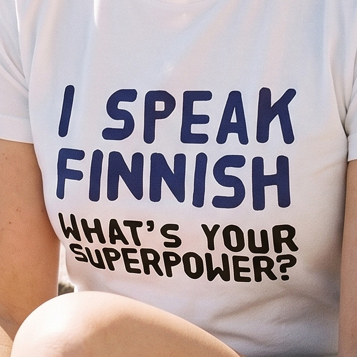 Close-up of the print on the white What's Your Superpower t-shirt, Very Finnish Problems