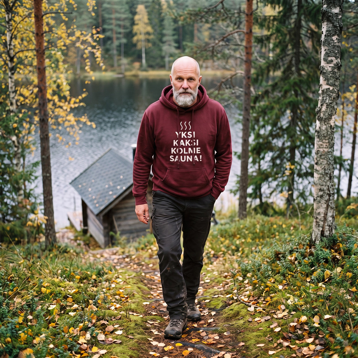 Yksi, kaksi, kolme, sauna! hoodie in maroon, worn by a man walking up the path from the lake sauna, Very Finnish Problems